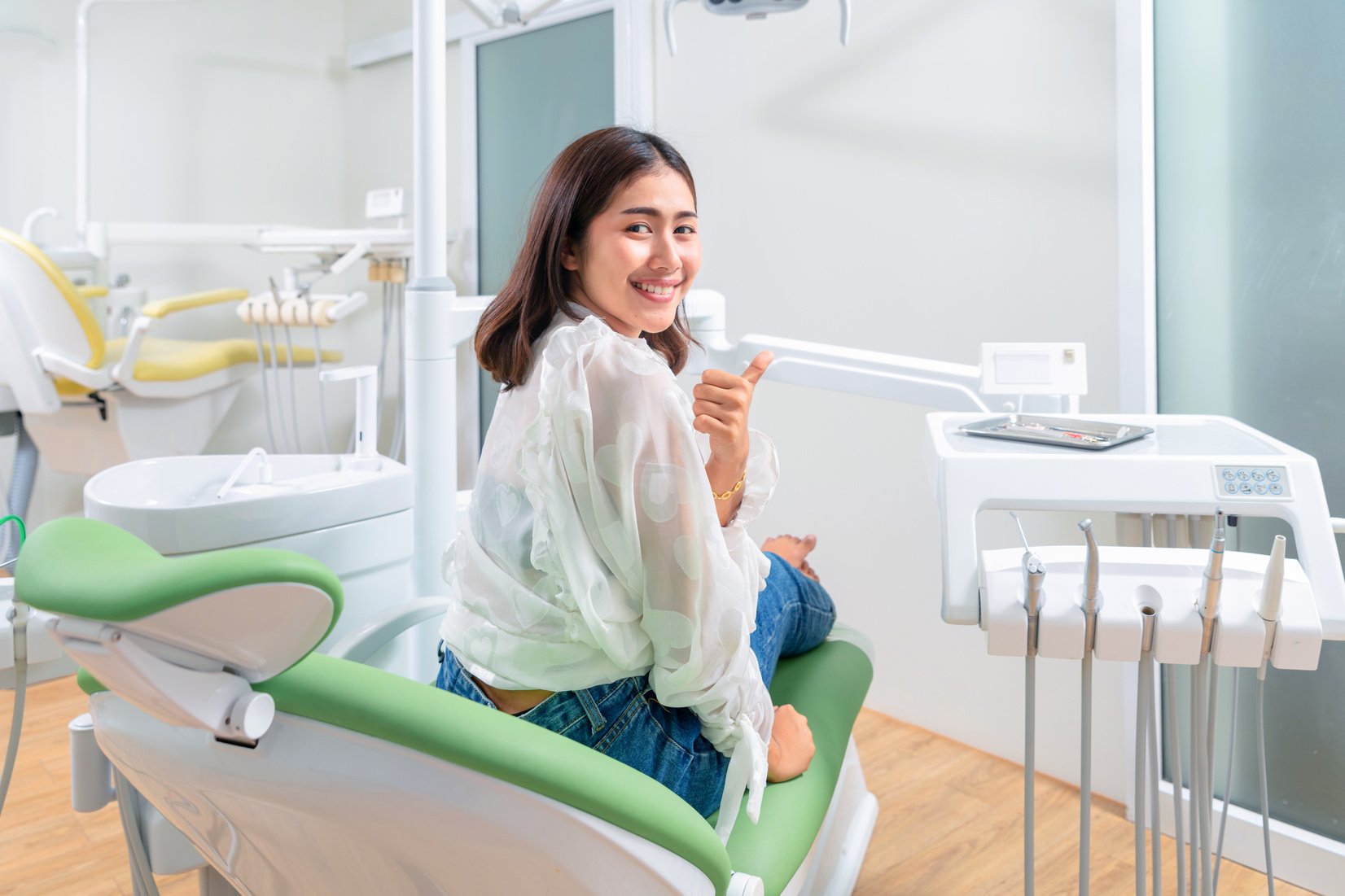 Happy dental patient in the dental chair